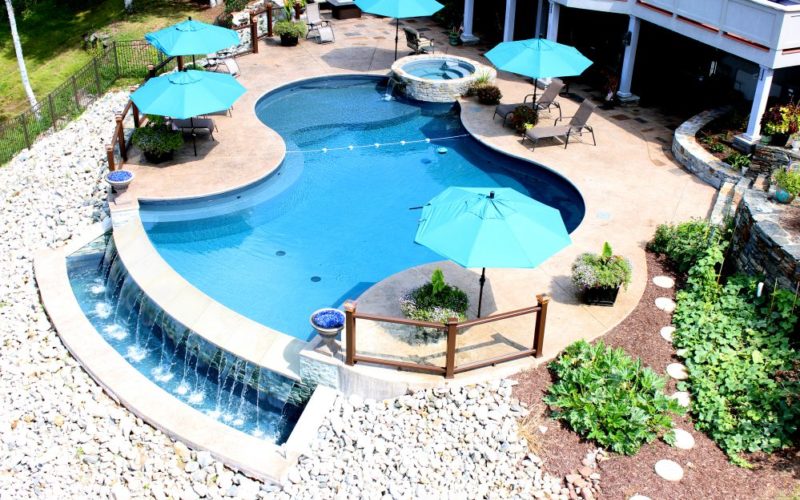Custom pool with overflow waterfall installed by Majestic Pools