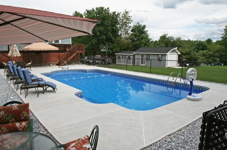 This is a photo of a patrician in ground pool with custom pool house.