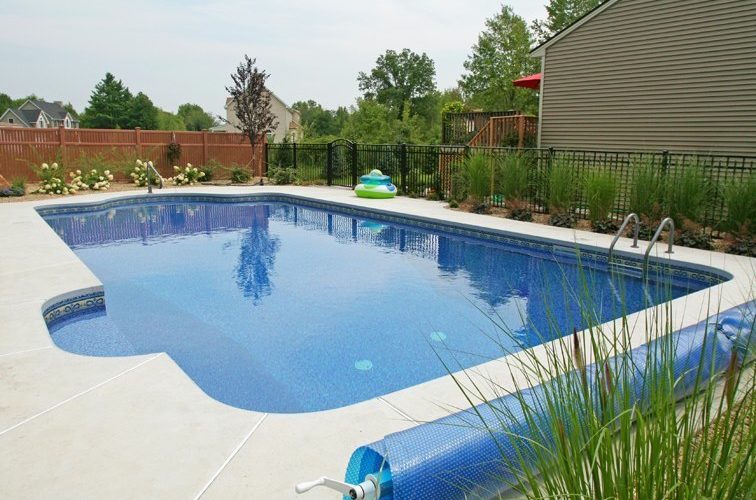This is a photo of a patrician in ground pool with solar cover.
